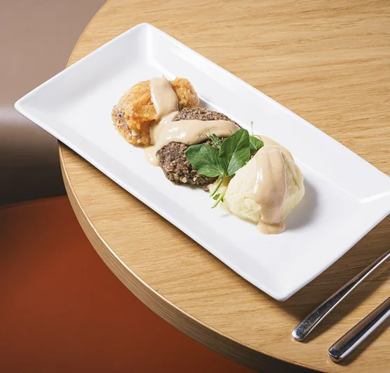 A main meal of Haggis with vegetable sides.