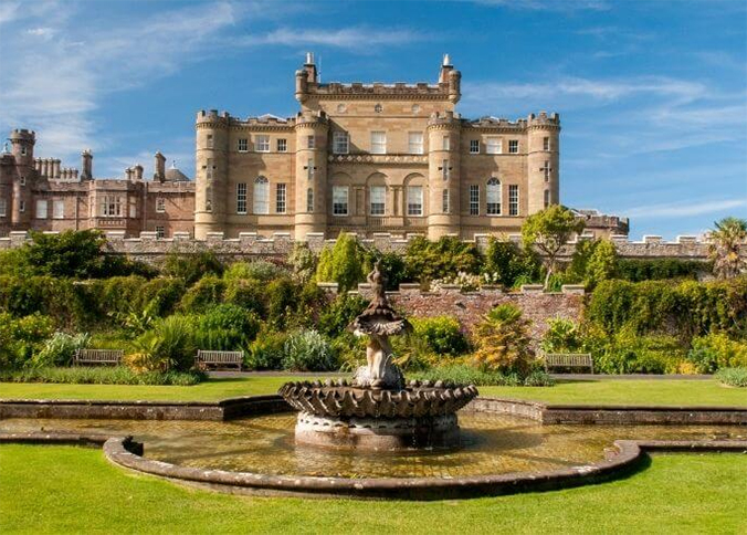 Calzean Castle, with the gardens and fountain in the foreground.