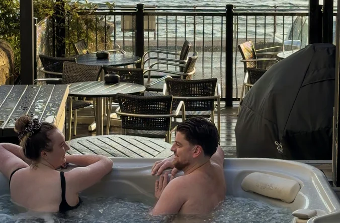 Man and woman in a hot tub at the Oban Hotel.
