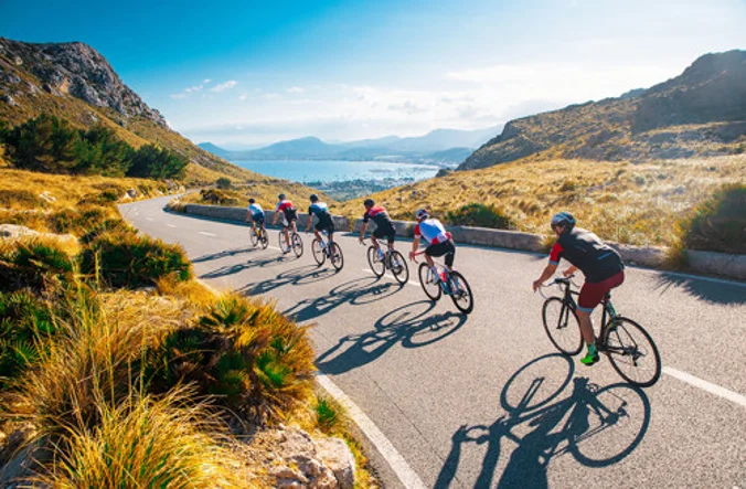 Cyclists travelling through a mountain range
