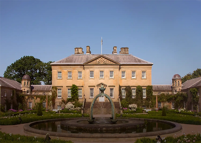 Exterior of Dumfries House on a cloudless sunny day. 