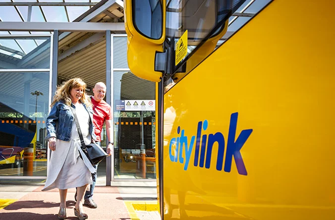 A couple embarking on the CityLink coach.