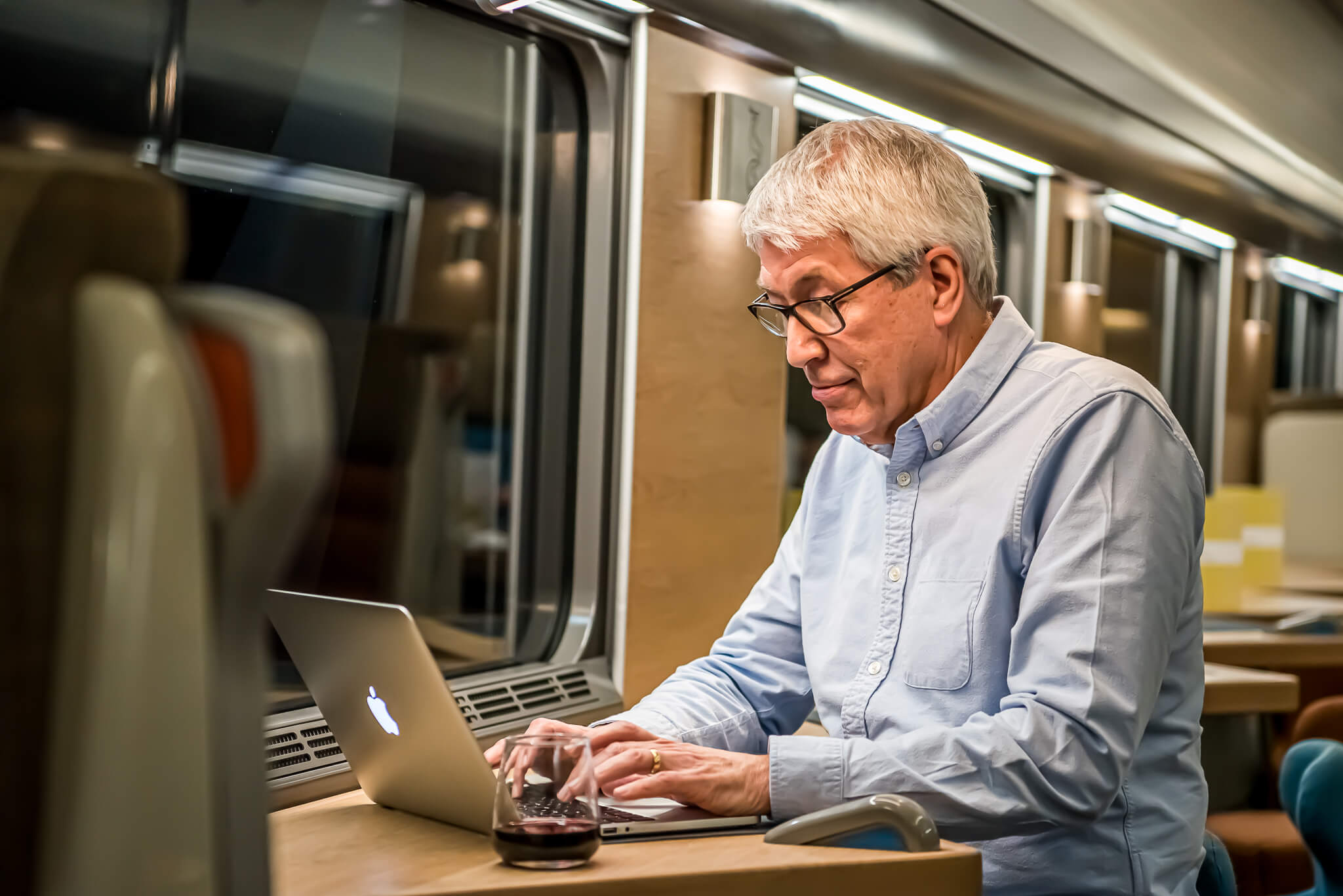 Man looking at laptop in Club Car
