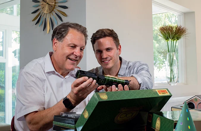 Two men inspecting a new Hornby model train.
