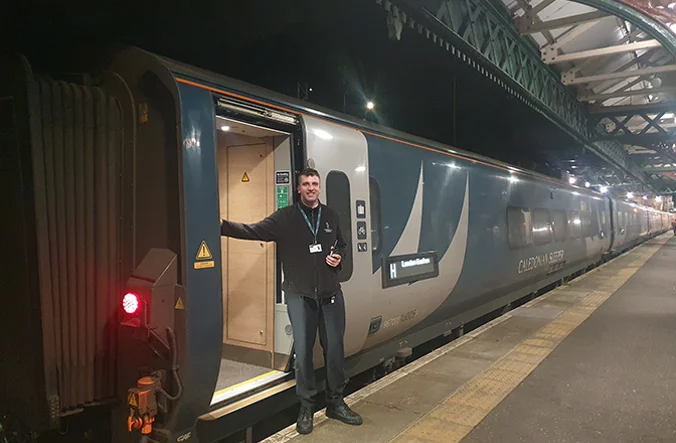 Representative of Caledonian Sleeper boarding the Caledonian Sleeper train.