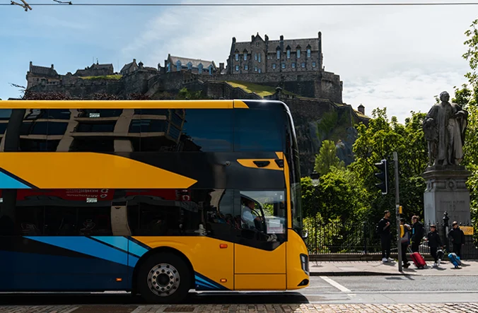 A double decker CityLink coach travelling through Edinburgh.