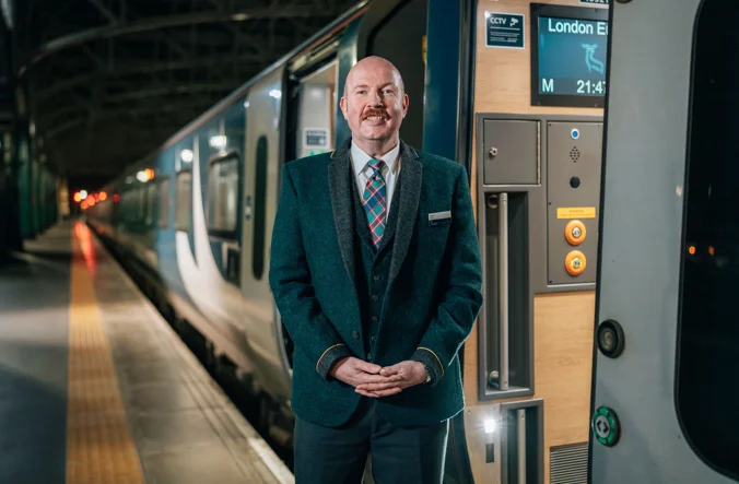 Representative for Caledonian Sleeper welcoming guests on board.