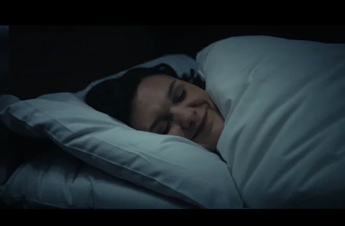 Woman sleeping in bed.