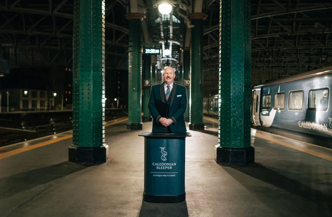 Representative for Caledonian Sleeper standing on platform.
