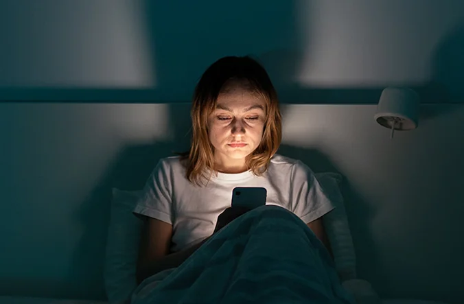Woman scrolling on her phone.