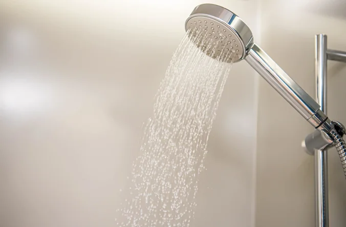 Shower head with water coming out of it