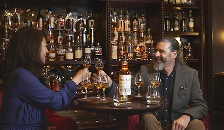A couple enjoying a drink at the Fife Arms Hotel in Braemar.